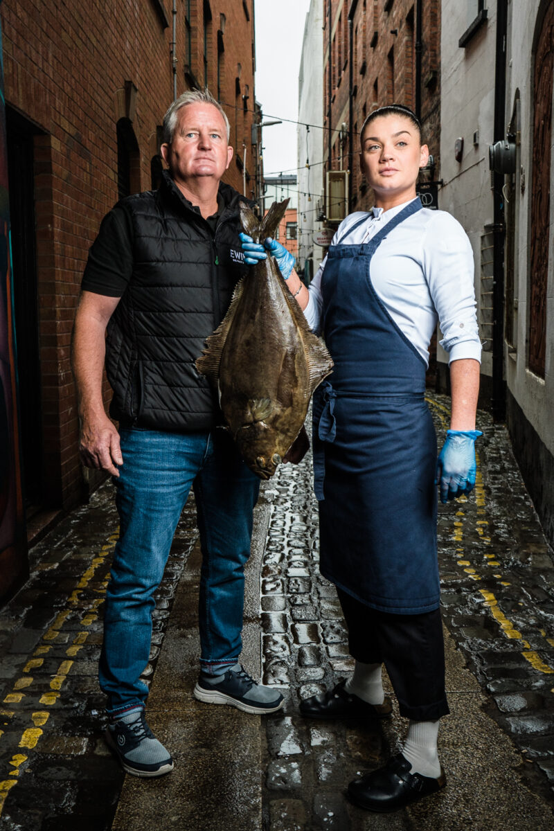 Warren Ewing' Ewing's Seafood with Chef Lottie Noren; Beau Restaurant. Photography: Elaine Hill, Belfast, Northern Ireland. - Ewing's Seafood supply Chef Lottie Noren with halibut in Belfast Cathedral Quarter